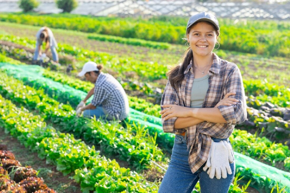 Young,Female,Farmer,Posing,While,Harvesting,In,Field