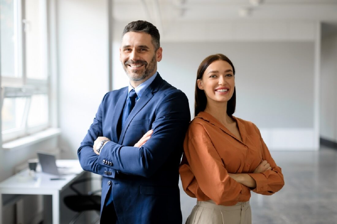 Successful,Happy,Businessman,And,Businesswoman,Standing,Back,To,Back,With