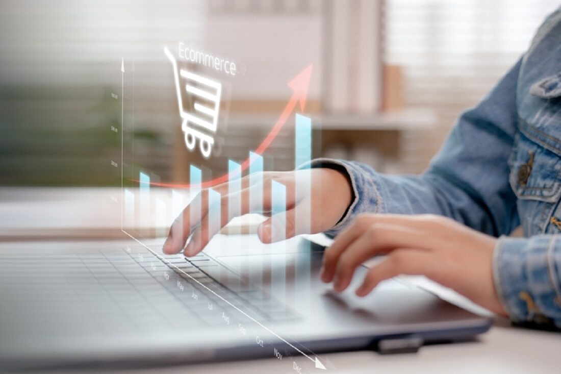 Hands,Typing,On,A,Laptop,With,An,Upward,Bar,Chart