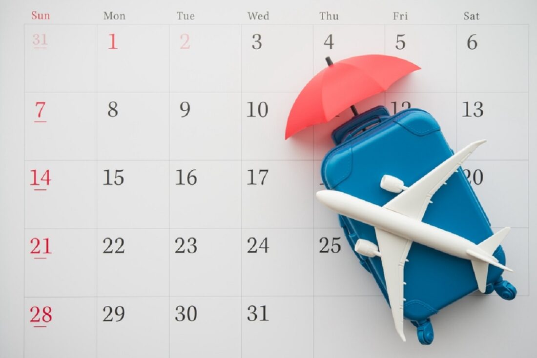 Airplane,,Suitcase,And,Umbrella,On,White,Calendar,Background.,Travel,Holiday