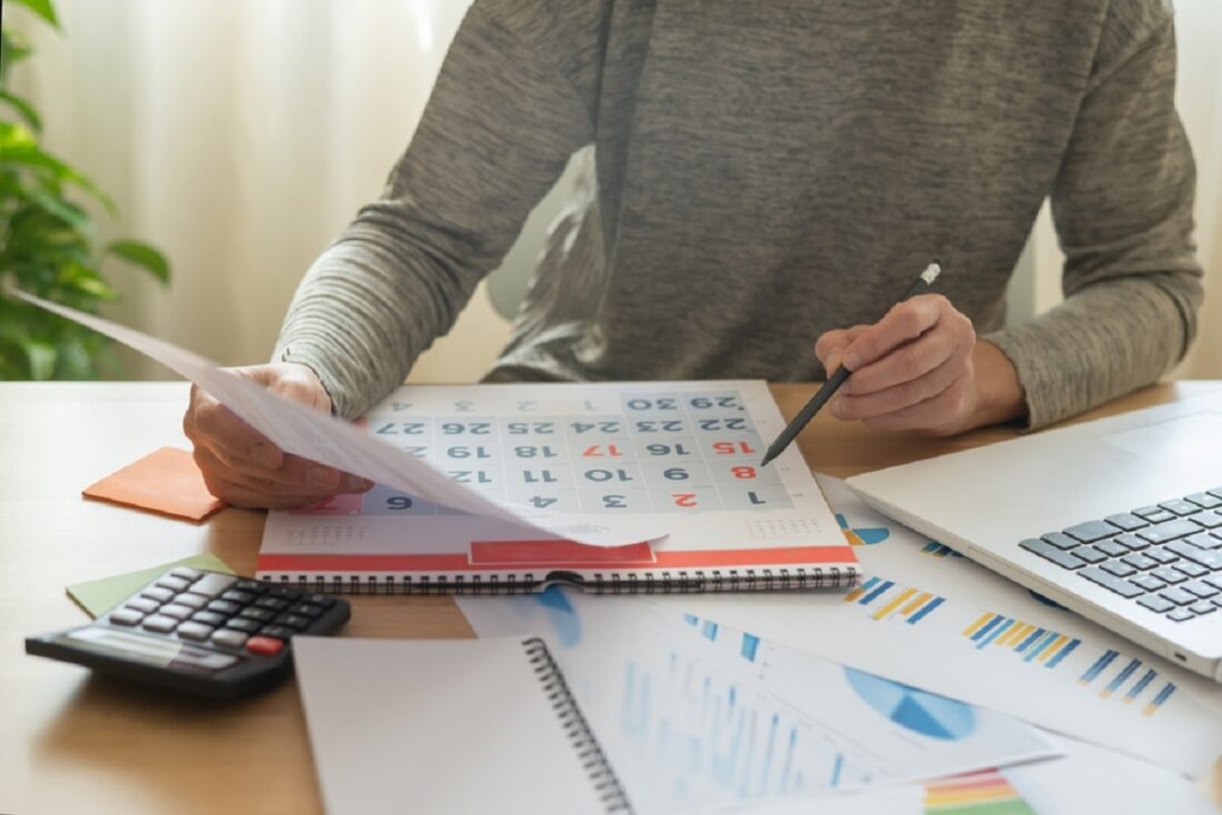 Business,Person,Looking,At,Calendar,To,Check:,Deadline,,Business,Invoices,