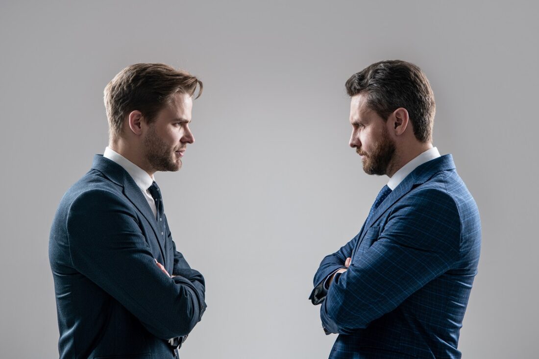 Two,Angry,Businessmen,Standing,Face,To,Face,Having,Struggle,For