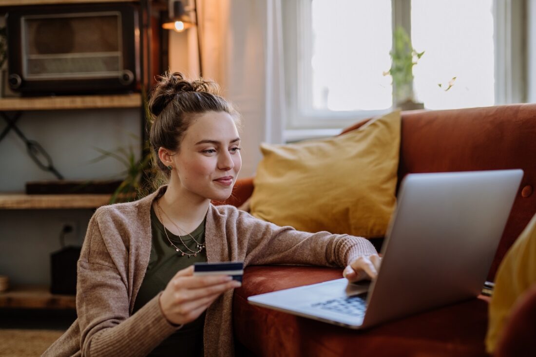 Young,Woman,Shopping,Online,In,Her,Apartment.