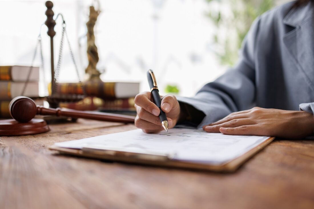 Lawyers,Discussing,Contract,Papers,Sitting,In,The,Table,At,Office