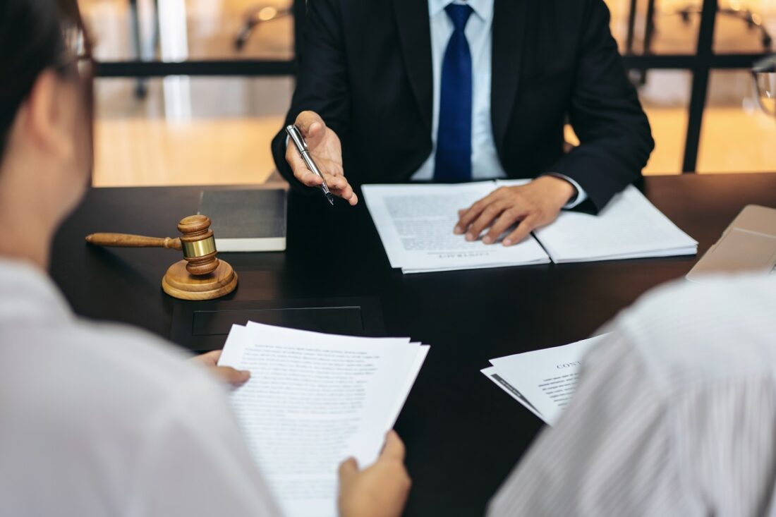 A,Man,In,A,Suit,Is,Sitting,At,A,Table