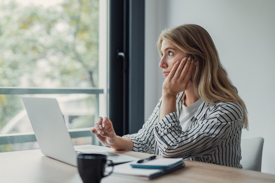 Young,Woman,Feeling,Bored,And,Distracted,From,Her,Work,At